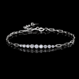 Kessane Bar Bracelet in 925 sterling silver with graduated round moissanite stones on a black background