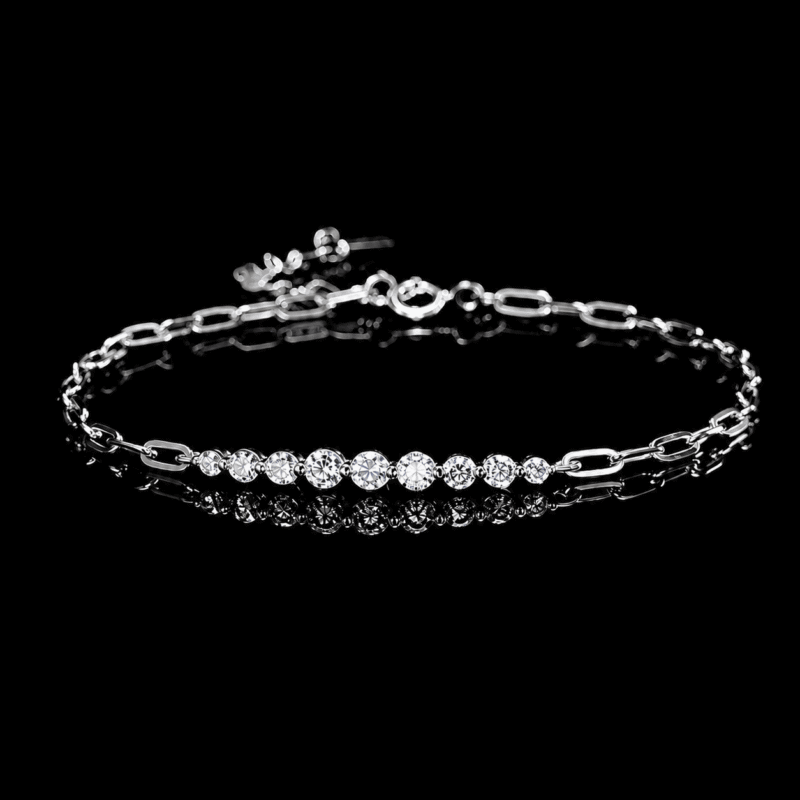 Kessane Bar Bracelet in 925 sterling silver with graduated round moissanite stones on a black background