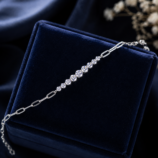 GLAMAVERA Kessane silver moissanite tennis bracelet displayed on a navy velvet jewellery box