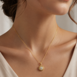 Woman wearing the gold Lyrane Halo Pendant Necklace by GLAMAVERA with an elegant neutral outfit
