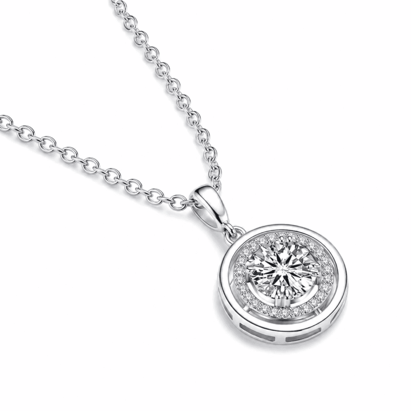 Angled close-up of the silver Lyrane Halo Pendant Necklace by GLAMAVERA with a round center moissanite and pavé halo