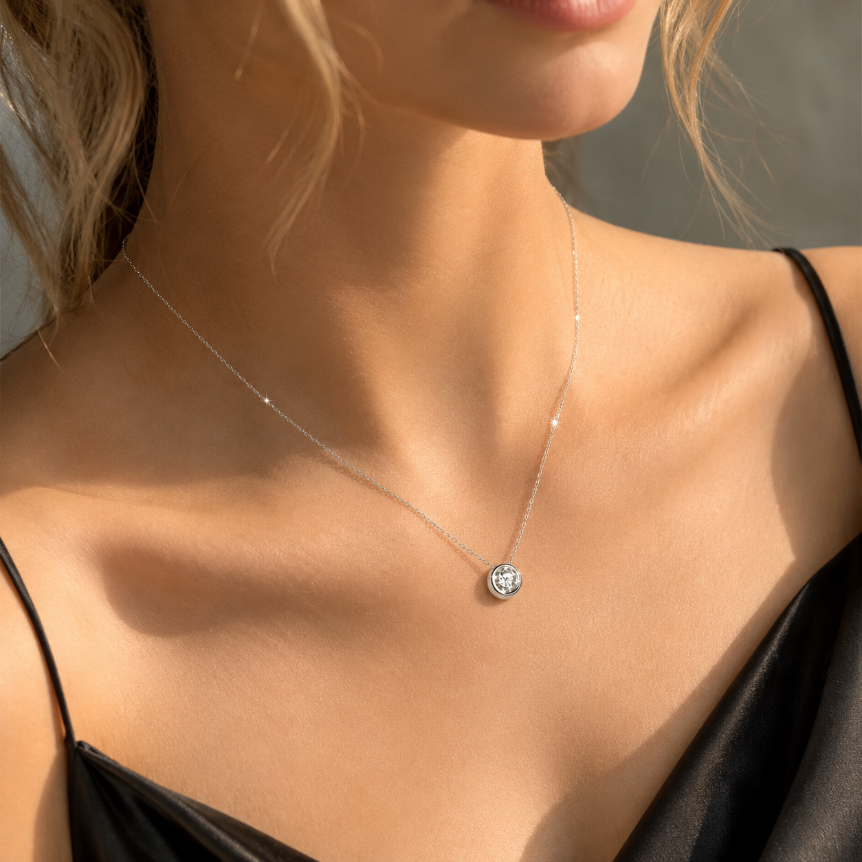 Silver pendant necklace worn by a model