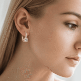 Woman wearing Rivane Drops gold-tone moissanite leverback earrings